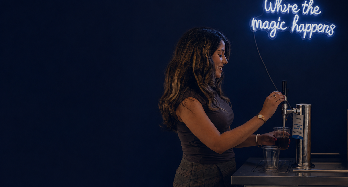 Team member pouring a drink at the office beverage station
